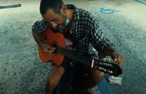 Regalan guitarra nueva al "Guitarrista de las calles" que toca en BK de la Domenech